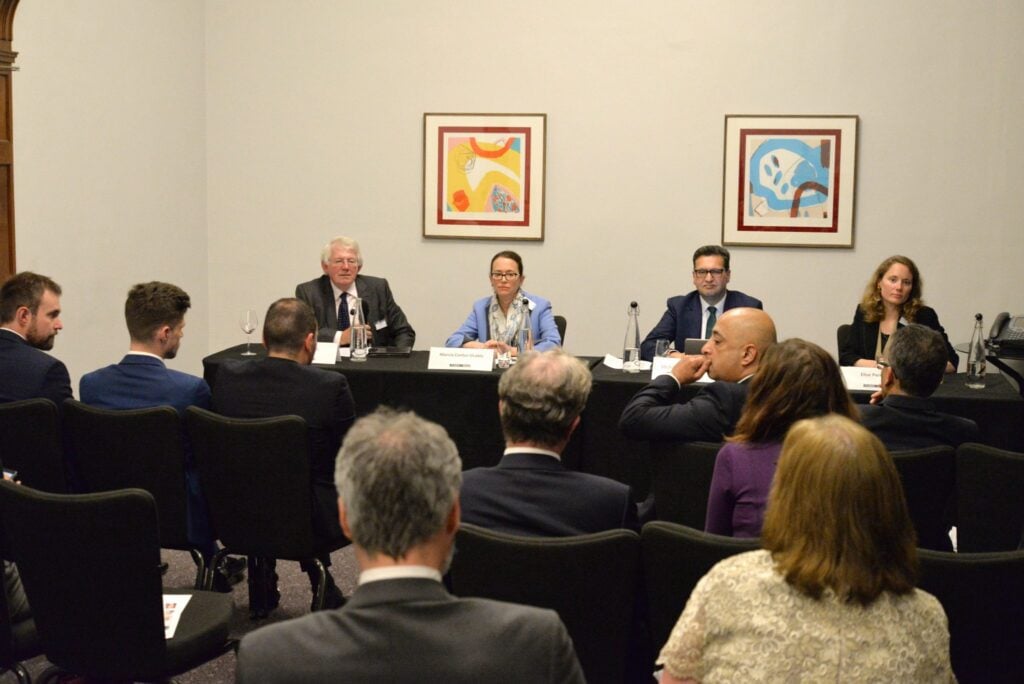 A diverse group of individuals from Nedonboard gathered around a table in a well-lit room, engaged in a discussion or meeting.