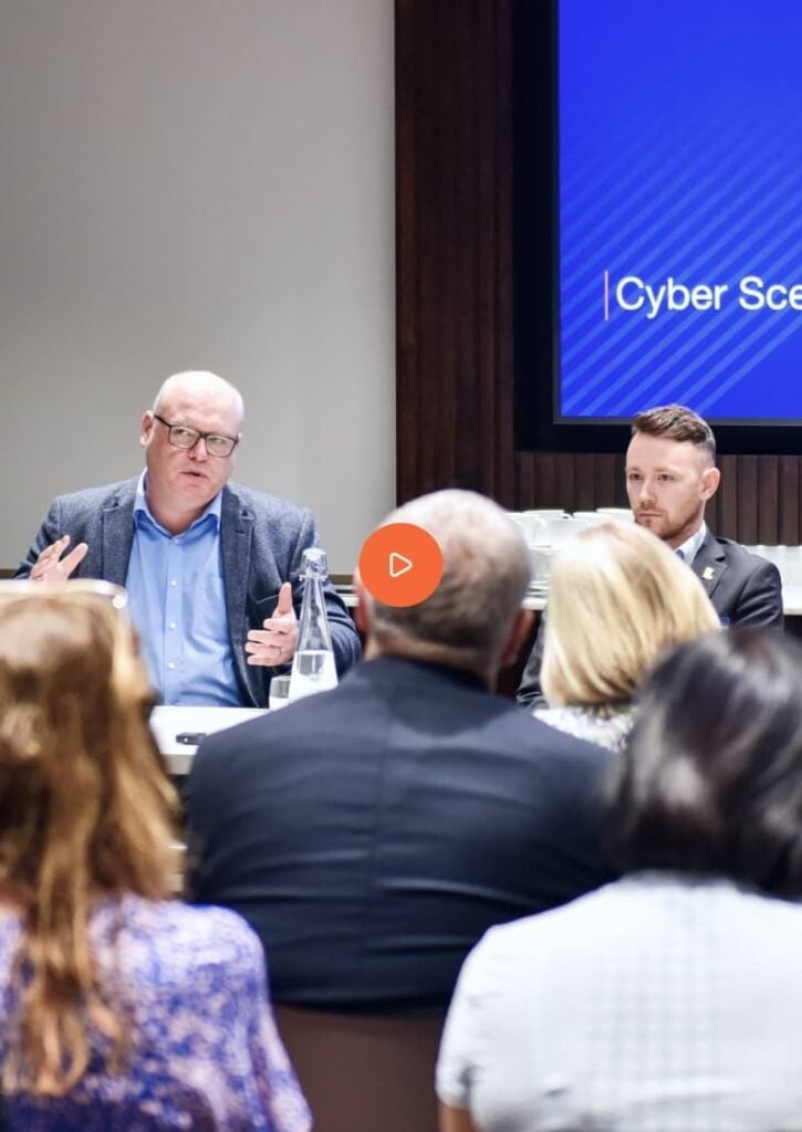 At the Nedonboard cyber security conference in London, experts passionately discussing digital threats and innovative solutions.